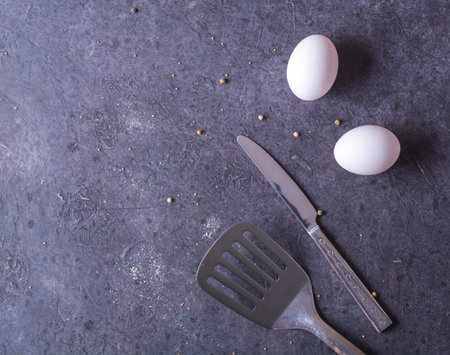 Fresh chicken eggs lying on a dark table. Plenty of room for text. cooking breakfast or eggs