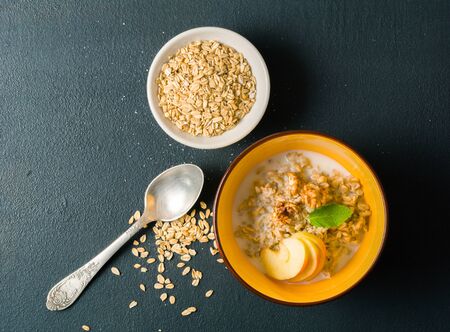 morning oatmeal for breakfast. Early morning and healthy diet food. Proper nutrition. Dark stone background. Plenty of room for text.の写真素材