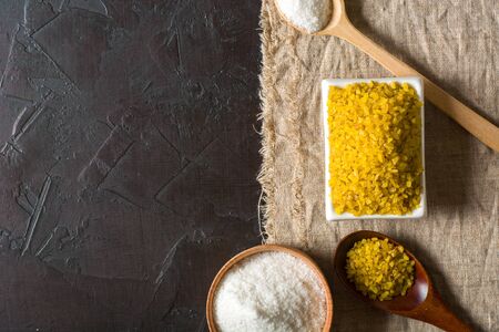 Bulgur on a dark background. wholesome organic food for breakfast or diet. Natural fabrics and earthenware. Copy space.の写真素材