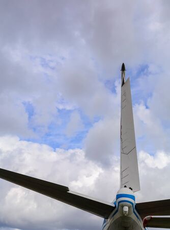 Airplane wing and stabilizer on a cloud background. Background for articles about aviation, travel or business trips.の写真素材