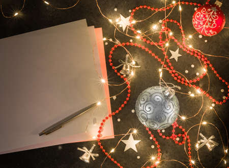 Preparation for New Years or Christmas greetings. Dark background, girlyadna and christmas decorations.の写真素材