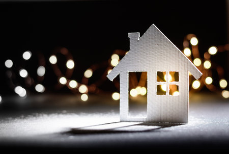 Small cardboard house on a dark winter background.の写真素材