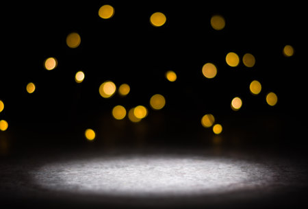 Dark background and bright blurred lights from behind. illuminated place in the foreground.の写真素材