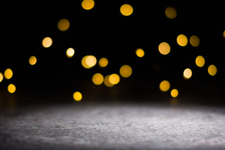 Dark background and bright blurred lights from behind. illuminated place in the foreground.の写真素材