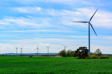 windmill wind turbines in field, power generator electric pylon wind turbineの写真素材