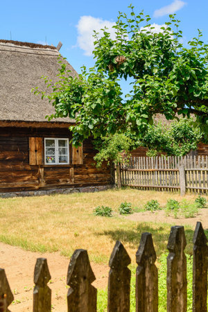 Small cozy houses. Wooden ancient buildings. Summer village and vacation. Farm bio products.の写真素材