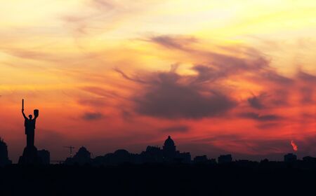 Kiev skyline with beautiful yellow sky at sunsetの写真素材