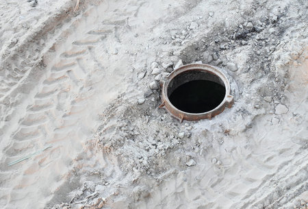 Carelessness of the workers at construction site: dangerous open manholeの写真素材