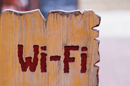 The wooden sign with Wi Fi text on itの写真素材