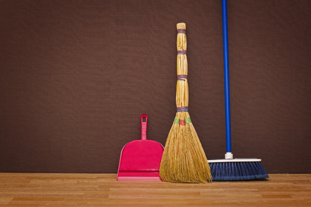 Cleaning up the apartment: brooms and a dustpanの写真素材