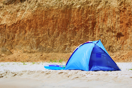 A touristic tent at the sea over the rocksの写真素材