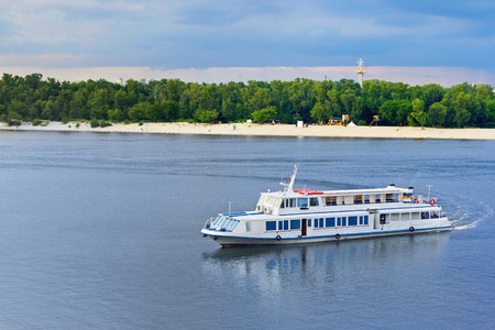 A touristic boat heading towards river port in Kiev, Ukraineの写真素材