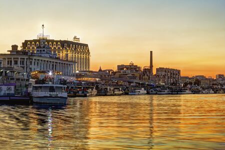 Kiev, Ukraine - August 9, 2016: View on the river bank of Poshtova Square and River Station at sunset. Tourists like to take a boat here and have an excursion.のeditorial素材