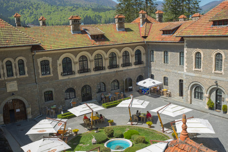 Busteni, Romania - 30 April, 2018: People having a good time an reastaurant in the courtyard of the...