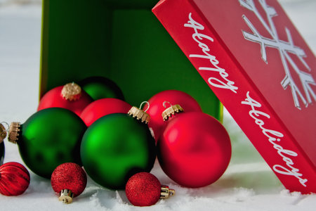 Happy Holiday Box of Red and Green Ornaments in the Snow
