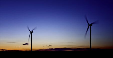 Two Wind Turbine Renewable Energy at Sunset Landscapeの写真素材