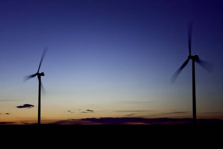 Two Wind Turbine Renewable Energy at Sunsetの写真素材
