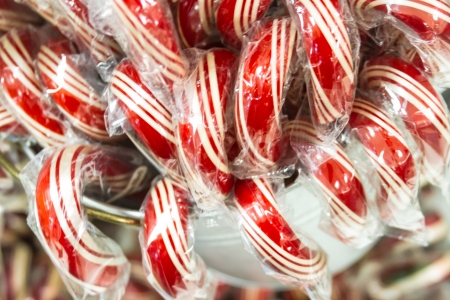 Bucket of red and white candy canes on displayの写真素材