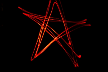 Red star shaped light streaks made by light paintingの写真素材
