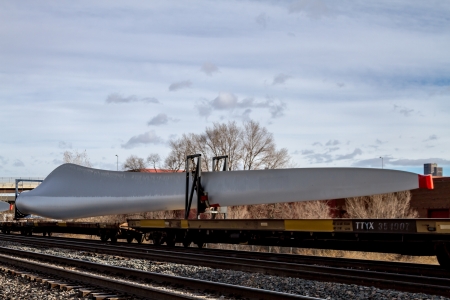 Single wind energy turbine blade on frieght train ready for transportのeditorial素材