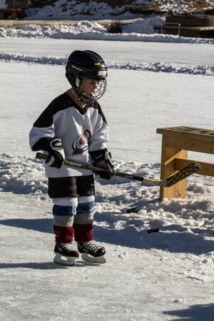Litte boy ice skating in hockey gearのeditorial素材