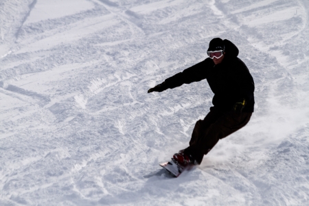 Male snowboarder skiing downhill at Ski Days during 50 Year Steamboat Springs winter celebrationのeditorial素材