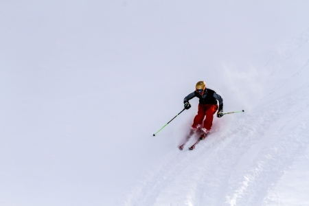 Male skier in red pants on fresh powder snow at Ski Days during 50 Year Steamboat Springs winter celebrationのeditorial素材