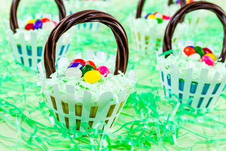 Easter basket cupcakes with colorful jelly beans and coconut grass
