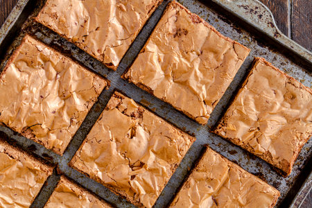Close up of homemade double chocolate chunk brownies sitting on metal baking pan