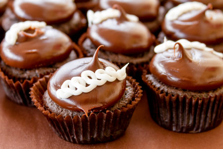 Chocolate cream filled cupcakes sitting on display tableの写真素材