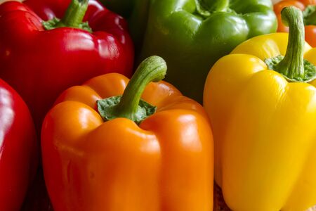 Close up of tops of assorted colorful bell peppersの写真素材