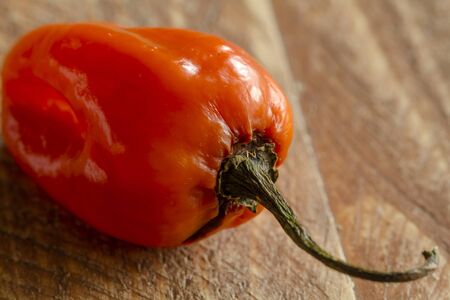 Close up of habanero pepper sitting on wooden tableの写真素材
