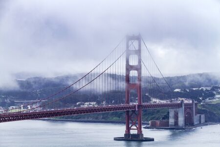 Close up of Golden Gate Bridge in San Francisco California on foggy morning surrounded with low lying cloudsのeditorial素材