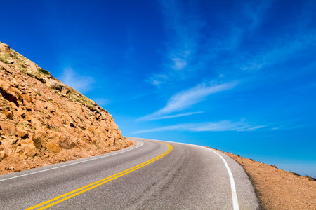 Mountain highway that seems to disappear into the sky