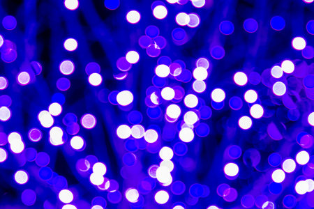 Abstract circular bokeh background of blue and white holiday lights