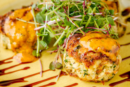 Pan seared blue crab cakes topped with roasted tomato basil aioli and micro green with balsamic...