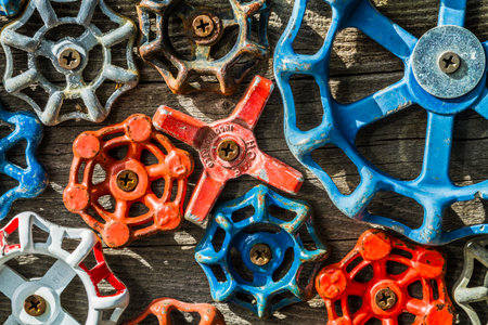 Close up of collection of aged water value knobs on wooden backgroundの写真素材