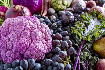 Pile of purple fruits and vegetables sitting on tableの写真素材