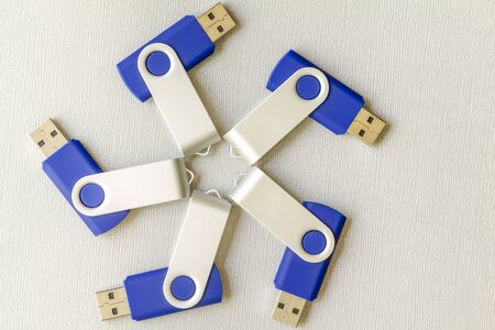 USB flash drives arranged in circle on gray background shot from aboveの写真素材
