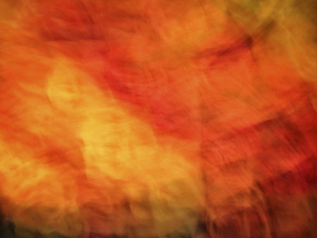 Bright artistic fire like background of red, orange and yellow textures, dynamic background. Artwork for creative graphic design or wall art.の写真素材
