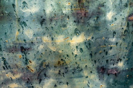 Texture of weathered, grungy and rusty background of patina on an old truck door with greens and bluesの写真素材