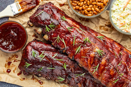 2 slabs of ribs sitting on brown paper with barbeque sauce brush, sides of cole slaw, baked beans...
