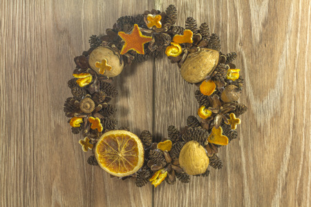 Christmas wreath on the type of wood backgroundの写真素材