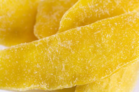 Dried mango slices on a white backgroundの写真素材