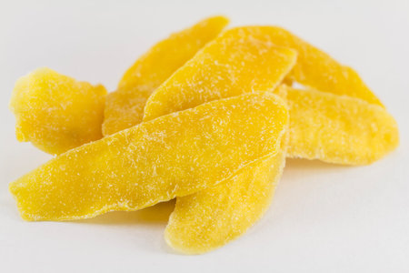 Dried mango slices on a white backgroundの写真素材