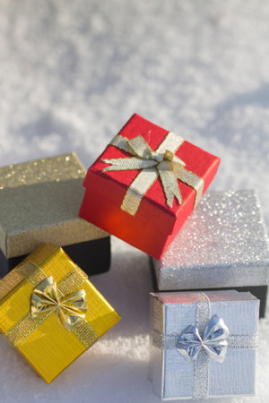 Christmas decoration boxs (silver, gold, red) on the snow