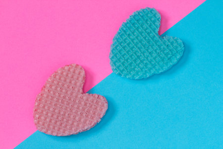 Creative heart from an edible wafer in pastel pink and blue colors. Abstraction. Template. Top view.の写真素材