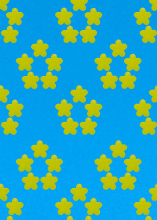 Abstract summer flower made of yellow candy on a blue background. Template. Macro. Top view.の写真素材