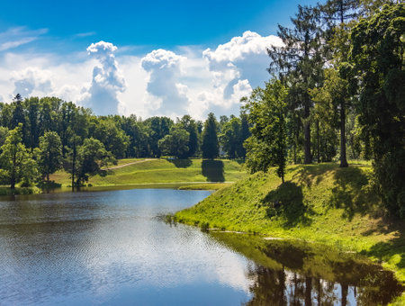 Beautiful summer landscape with lake, forest and blue sky with cloudsの写真素材