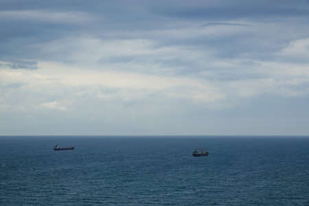 Amazing tropical panoramic view of turquoise bay, sandy beach, green mountains and plants, blue sky, white clouds background, Capo Vaticano rock platform, Calabria, southern Italy.の写真素材